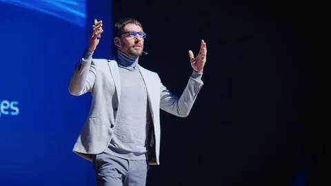 Startup Executive Introduces Software Engineer on Stage who Presents New Product Stock Footage 122814565