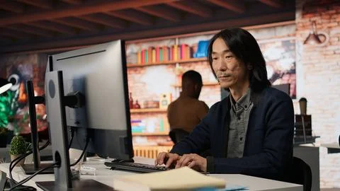 Startup manager leveraging machine learning technology in office Stock Photos