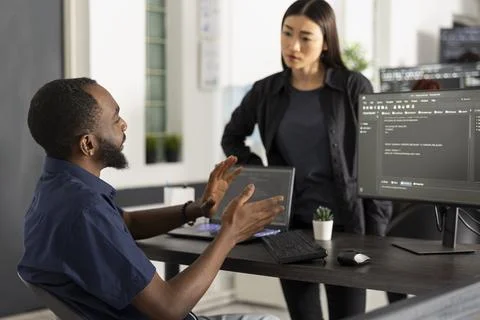 Startup Manager Reviewing App Data with Team Member Photos