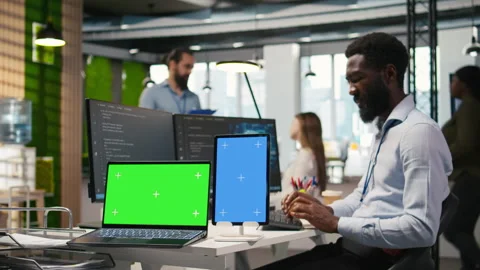 Startup office admin reviewing AI system metrics on isolated screen devices Stock Footage 313016084
