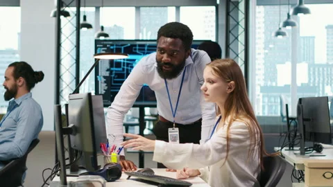 Startup office manager congratulates young girl after developing AI models Stock Footage 313166582
