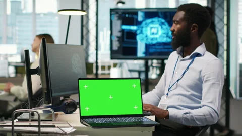 Startup office programmer using green screen laptop, developing AI models Stock Footage 313165554