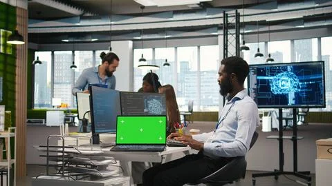 Startup office programmer using green screen laptop, developing AI models Stock Photos