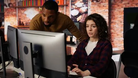 Startup office supervisor checking up on IT expert using artificial intelligence 写真素材