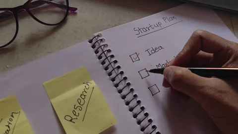 Startup Plan Checklist in Notebook Business Research Market Growth Strategy Stock Footage 329184969