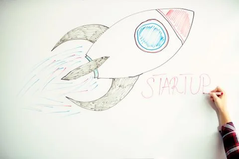 Startup rocket on whiteboard Stock Photos