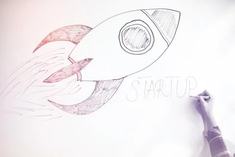 Startup rocket on whiteboard Stock Photos