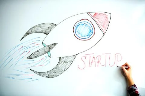 Startup rocket on whiteboard Stock Photos
