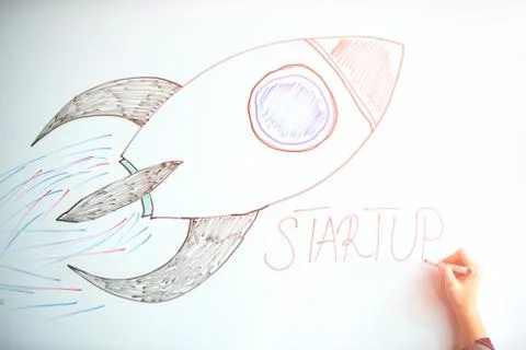 Startup rocket on whiteboard Stock Photos