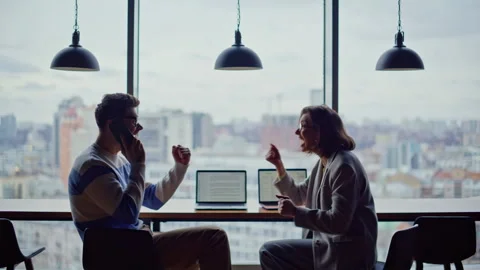Startup team calling phone getting good news at window. Colleagues giving five Stock Footage 335244003