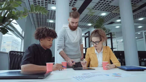 Startup team discussing company progress in office Stock Footage 163342119