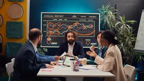 Startup team evaluating infographics data in an executive meeting, Stock Photos