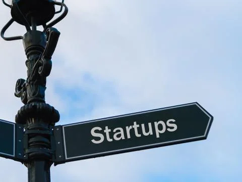 Startups directional sign on guidepost Stock Photos