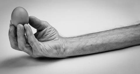 Starving hand with egg Stock Photos