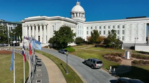 State flags of each American US state. Aerial at Alabama Capitol building. Stock Footage 220755592