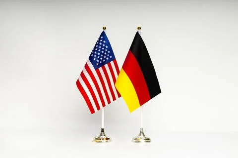 State flags of the USA and Germany on a light background. Stock Photos