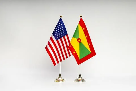 State flags of the USA and Grenada on a light background. Stock Photos