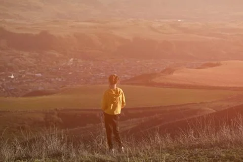 State of mind concept of one lonely thin little girl in yellow hoodie standin Stock-Fotos