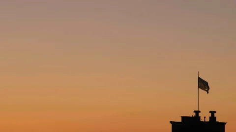 State torn flag of Ukraine on the building. flag at sunrise flutters in the wind Stock Footage 116296373
