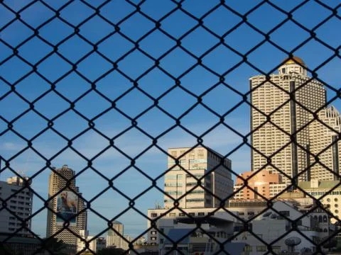 State Tower with a blue sky from a rooftop cage. Bangkok, Thailand. Hang Over Stock Photos