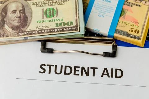 Statement form of student aid and money on the table. Stock Photos