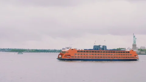 Staten Island Ferry passes in front of the Statue of Liberty Stock Footage 76540762