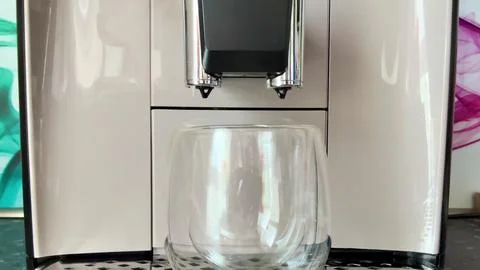 A stateoftheart Modern Coffee Machine that comes with a sleek Glass Mug for Stock Photos