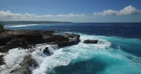 STATIC 4K AERIAL OF OCEAN WAVES HITTING ROCK CLIFFS Stock Footage 60042198