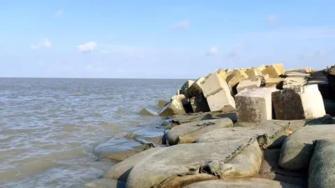 Static 4K Shot of Coastal Breakwater and Gentle Ocean Waves Stock Footage 338020189