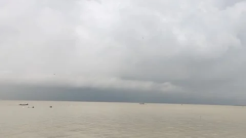 Static 4K Water Landscape with Dramatic Cloudy Sky and Distant Boats Stock Footage 338116031