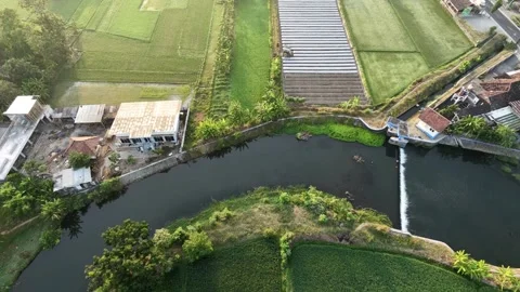 Static aerial drone view of river dam and green agricultural fields in rural vil 스톡 동영상 342086401