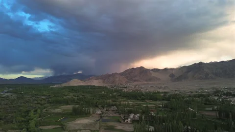 Static aerial establishing shot of a dramatic storm and golden sunset over a Stock Footage 339157916