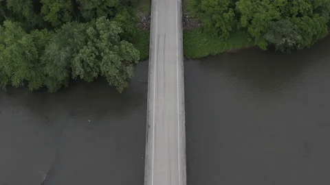 Static aerial shot of bridge over river as car passes bottom to top. Video stock 133090438