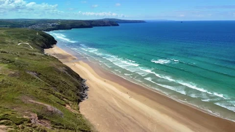 Static Aerial Shot of Coast as Waves Roll on to Sandy Beach, Cornwall, UK Stock Footage 310135460