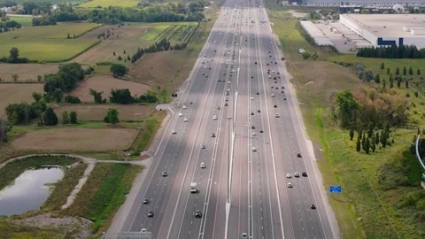 Static aerial shot of major freeway field on both sides city in the distance Stock Footage 250489783