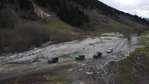 Static aerial shot of an off-road convoy on a mountain road Stock Footage 337712214