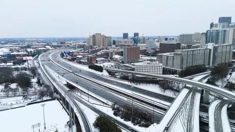 Static aerial shot of snow covered interstate 75-85 South in Downtown Atlanta Stock Footage 306128508