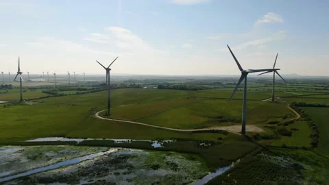 A static aerial shot of a Wind Farm in County Wexford, Ireland. Video stock 155309535