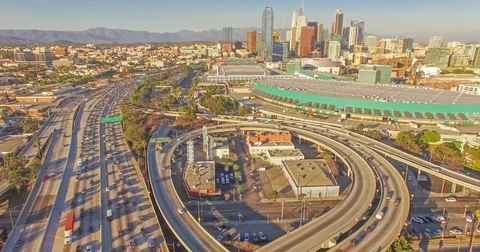 Static aerial timelapse view of heavy traffic on a freeway and skyscrapers Stock Footage 70610179