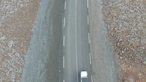Static aerial top down view white 4x4 car drives on on two lane asphalt road  Stock Footage 158170219
