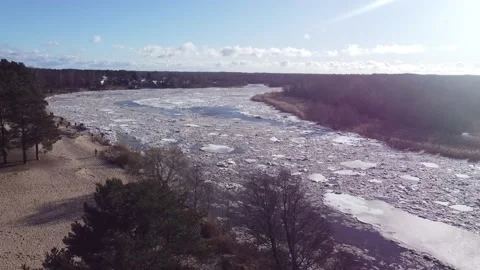 Static aerial view of a huge blocks of pack ice going down the river Gauja Stock Footage 149819149