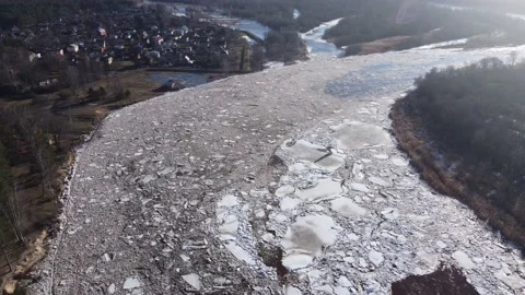 Static aerial view of a huge blocks of pack ice going down the river Gauja Stock Footage 149819225