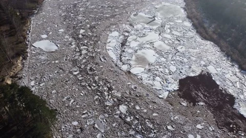 Static aerial view of a huge blocks of pack ice going down the river Gauja Stock Footage 149819257