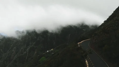 Static aerial view - large clouds fly very low over a lonely road without cars Stock-Footage 111309025
