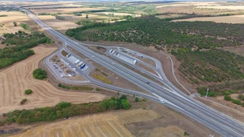 Static aerial view of M4 motorway rest area by farmland and forest near Gerje Stock Footage 344881473