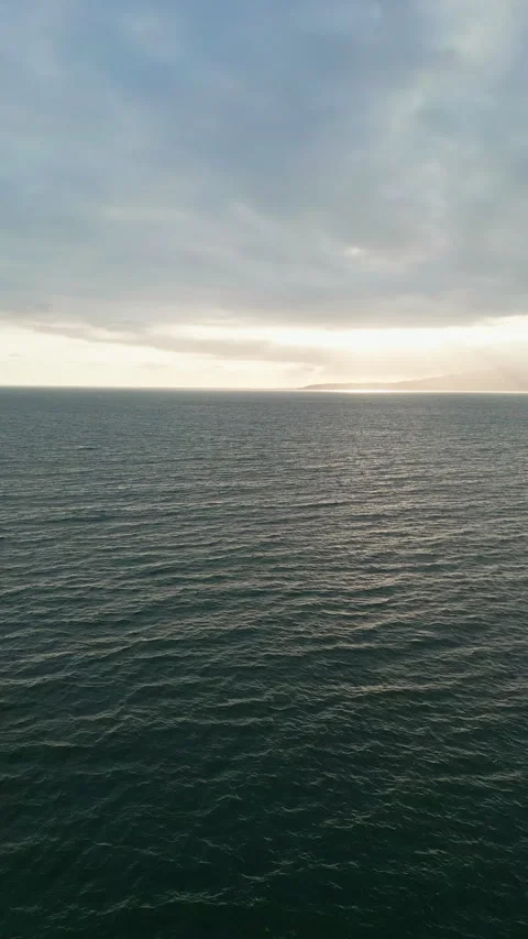 Static aerial view over the open Pacific Ocean under overcast sky Stock Footage 342089768