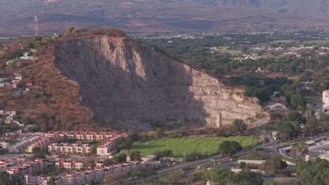 Static aerial view of quarry, road, and residential area at sunset in Yautepec Video stock 328263589