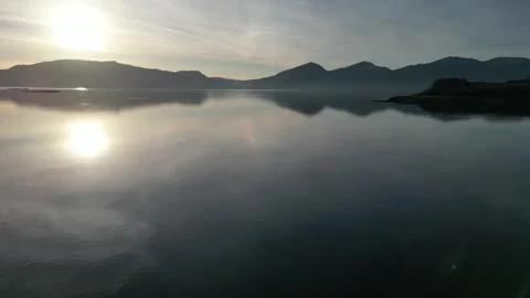 Static aerial view of reflective lake and hills in Scotland 動画素材 334459480