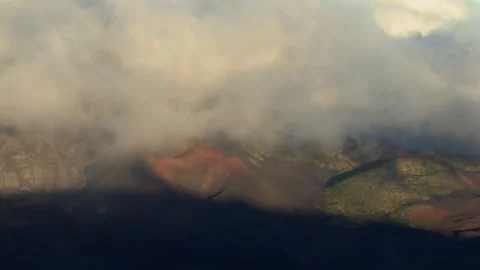 Static aerial view of volcanic cinder cones beneath low clouds in Waikamoi Stock Footage 339899893