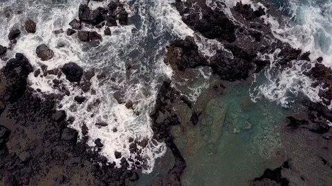 Static Aerial View Of Waves Crashing On Rocky Coastline Video stock 78106776